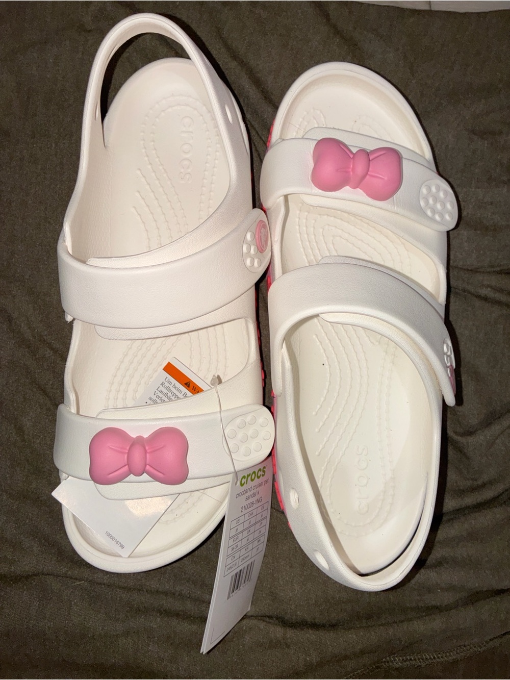 1️⃣ CROCS Kids White Sandals with Pink Bow Accents